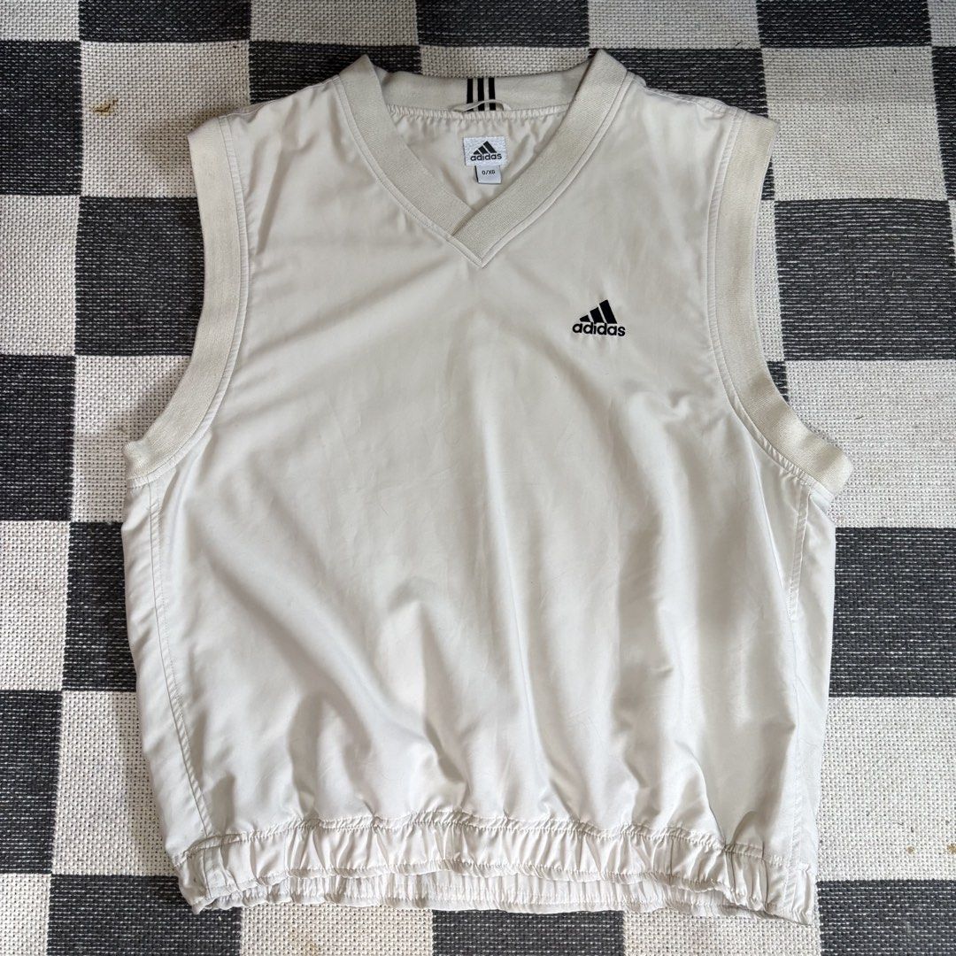 Adidas Golf Vest (Category: Coats, Jackets and Outerwear) located in Makati City. Submitted by sseurekiii (Listing ID 1463346914, Image 1). Description: - White Adidas vest - Sleeveless with V-neck - Elasticated hem for a snug fit - Features iconic Adidas logo on chest - Three stripes detail on the collar - Lightweight and versatile for layering or solo wear.