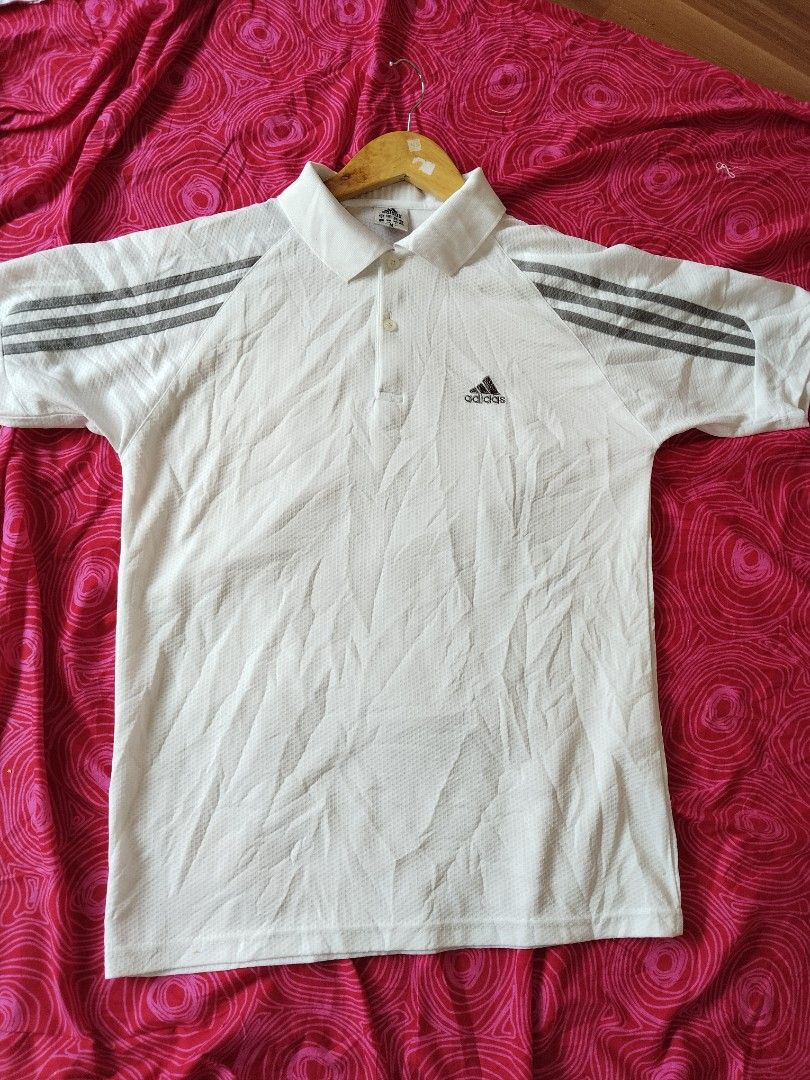 Adidas Polo White (Category: Tshirts & Polo Shirts ) located in Mabalacat. Submitted by al_amin_thrift (Listing ID 1463353364, Image 1). Description: ⚽ Adidas Classic 3-Stripes Performance Polo — White L25 W20 Brand: Adidas Size: M (UK 8 / EU 40) — Regular Fit Color: White with Dark Grey 3-Stripes on Sleeves Fabric: Breathable perforated mesh — lightweight, quick-dry, moisture-wicking ✨ Details: - Embroidered Adidas logo on left chest — clean & s