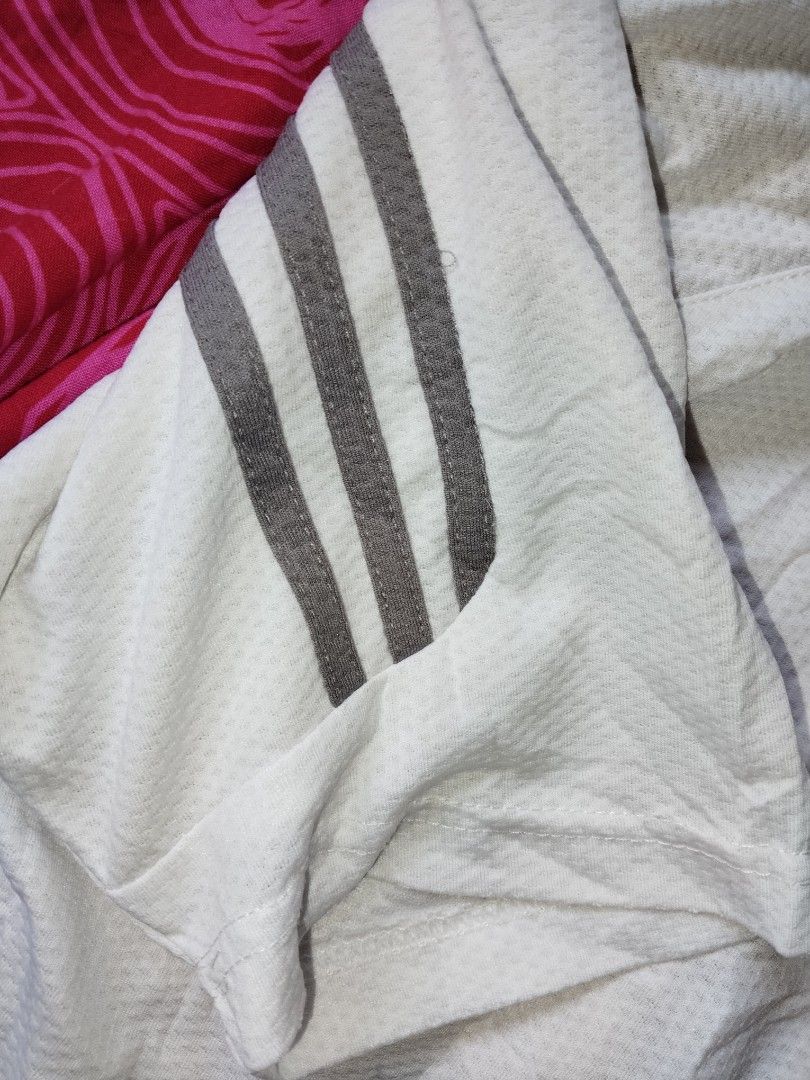 Adidas Polo White (Category: Tshirts & Polo Shirts ) located in Mabalacat. Submitted by al_amin_thrift (Listing ID 1463353364, Image 2). Description: ⚽ Adidas Classic 3-Stripes Performance Polo — White L25 W20 Brand: Adidas Size: M (UK 8 / EU 40) — Regular Fit Color: White with Dark Grey 3-Stripes on Sleeves Fabric: Breathable perforated mesh — lightweight, quick-dry, moisture-wicking ✨ Details: - Embroidered Adidas logo on left chest — clean & s