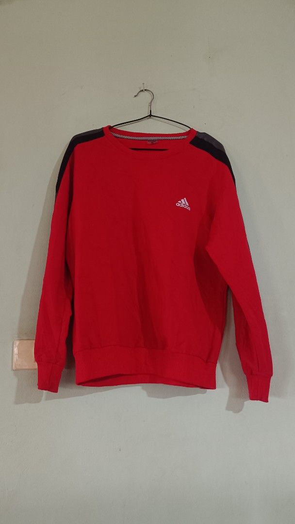 Adidas Red Crewneck Sweatshirt Size M (Category: Coats, Jackets and Outerwear) located in Taguig. Submitted by redarmy21775000 (Listing ID 1463344645, Image 1). Description: - Classic Adidas sweatshirt in size M. - Features the iconic Adidas logo on the chest. - Stylish dark grey panels on shoulders and sleeves. - Comfortable ribbed cuffs and hem. - Made from a soft cotton blend..