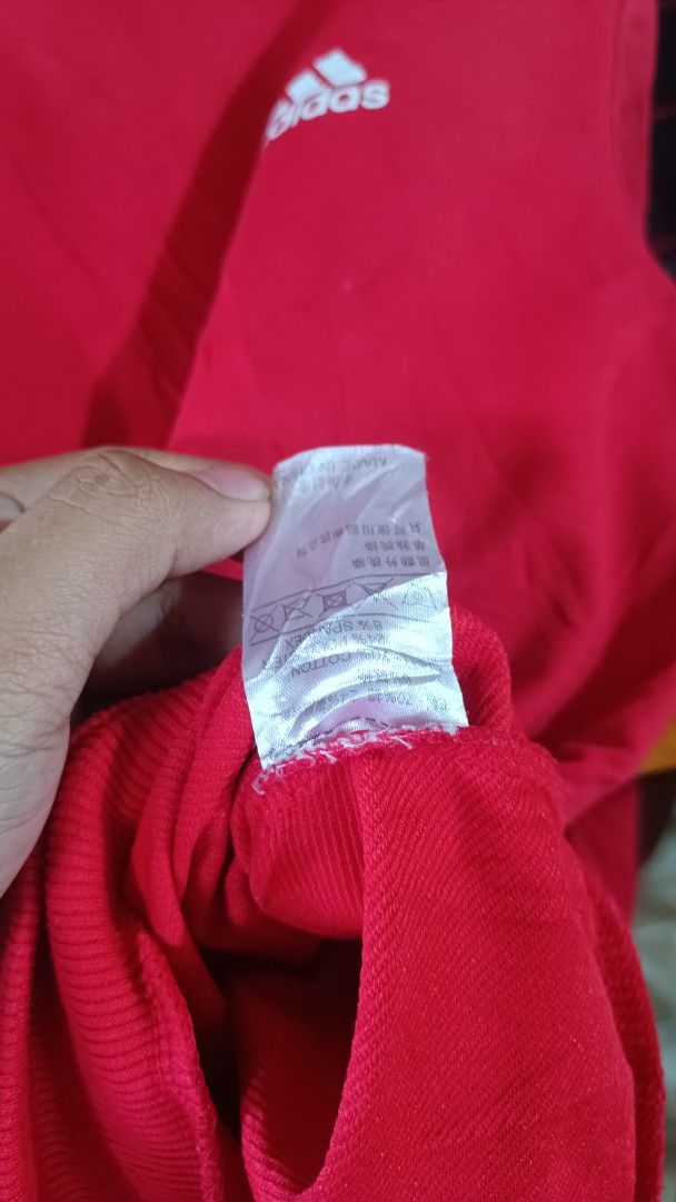 Adidas Red Crewneck Sweatshirt Size M (Category: Coats, Jackets and Outerwear) located in Taguig. Submitted by redarmy21775000 (Listing ID 1463344645, Image 2). Description: - Classic Adidas sweatshirt in size M. - Features the iconic Adidas logo on the chest. - Stylish dark grey panels on shoulders and sleeves. - Comfortable ribbed cuffs and hem. - Made from a soft cotton blend..