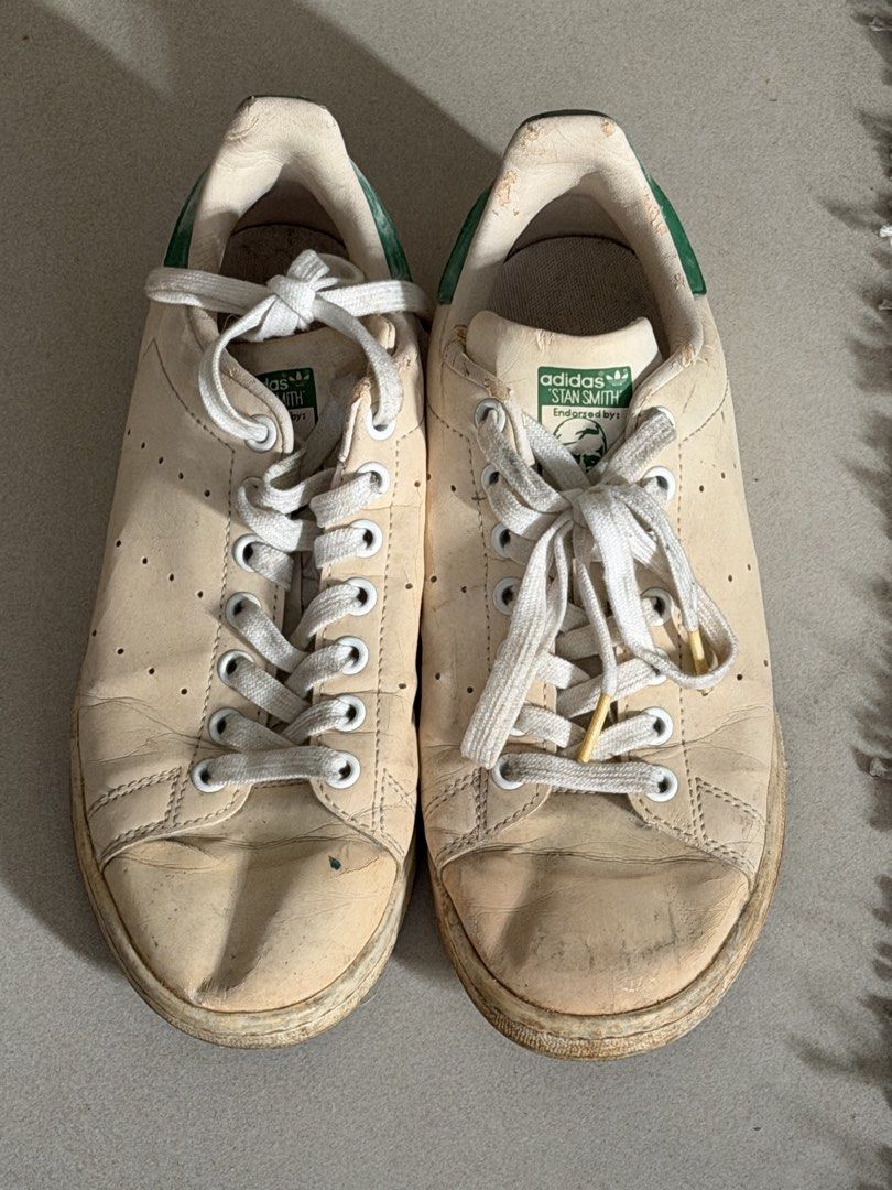 Adidas Stan Smith Sneakers Green White (Category: Sneakers) located in Taguig. Submitted by anxmz (Listing ID 1463425125, Image 1). Description: - Classic Adidas Stan Smith sneakers - Color: Cream white leather with green heel accents - Size: 7 US Women's - Condition: Used, with visible wear on soles and toe box - Laces: White - Perfect for casual everyday wear.
