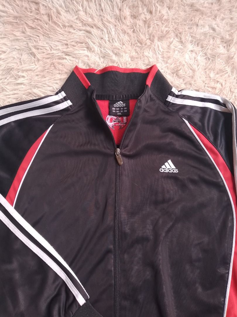 Adidas Track Jacket Black Red White Stripes (Category: Coats, Jackets and Outerwear) located in Caloocan City. Submitted by hoodiegeng (Listing ID 1463397580, Image 2). Description: - Classic Adidas track jacket - Color: Black with red and white accents - Iconic three stripes on sleeves - Full zip closure - Ribbed cuffs and hem - Ideal for casual wear or sports.