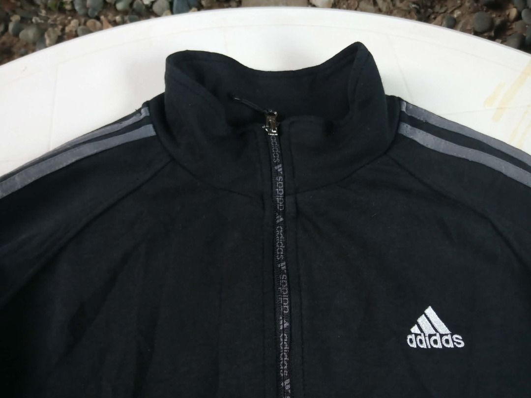 Adidas Track Jacket Black with Grey Stripes (Category: Coats, Jackets and Outerwear) located in Pasig City. Submitted by rjkfindsofficial (Listing ID 1463408983, Image 2). Description: - Large on tag - Dimes L26 x W21 - All zipper working - Tags mismatch - Classic black Adidas track jacket - Iconic three stripes on sleeves - Full zip closure - Convenient pockets - Made in Morocco - Comfortable cotton and polyester blend - Ideal for sports or casu