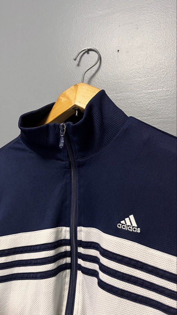 Adidas Track Jacket Navy Blue White Stripes (Category: Coats, Jackets and Outerwear) located in Cabuyao City. Submitted by bulandos (Listing ID 1463438795, Image 2). Description: - Classic Adidas track jacket - Navy blue with white stripes across the chest - Full zip closure - Ribbed collar, cuffs, and hem - Versatile for casual wear or sports - Features Adidas logo on the chest.