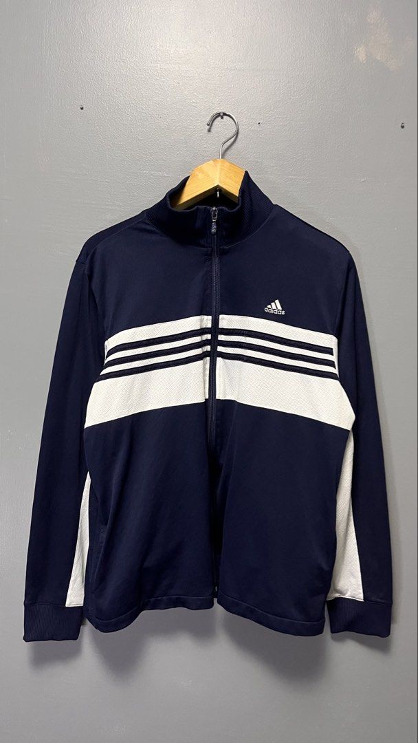 Adidas Track Jacket Navy Blue White Stripes (Category: Coats, Jackets and Outerwear) located in Cabuyao City. Submitted by bulandos (Listing ID 1463438795, Image 1). Description: - Classic Adidas track jacket - Navy blue with white stripes across the chest - Full zip closure - Ribbed collar, cuffs, and hem - Versatile for casual wear or sports - Features Adidas logo on the chest.
