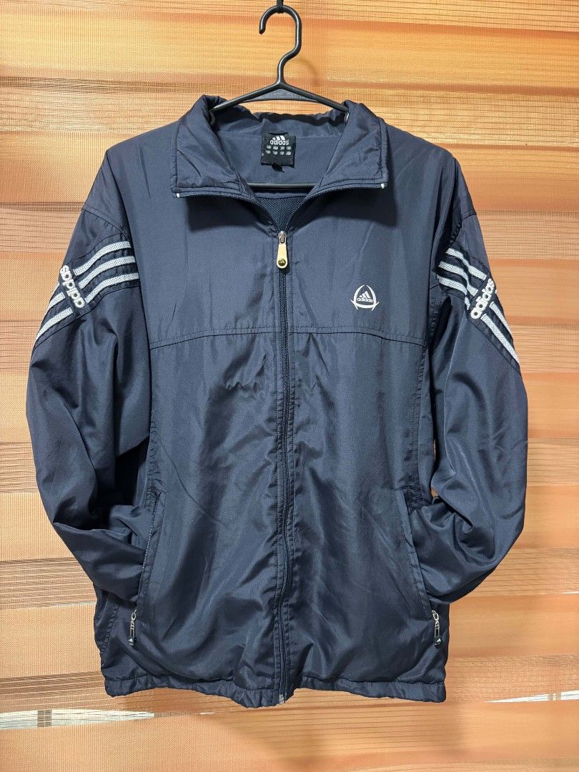Adidas Windbreaker Jacket Navy Blue (Category: Coats, Jackets and Outerwear) located in Makati City. Submitted by rexb1993 (Listing ID 1463494549, Image 1). Description: - Classic navy blue Adidas windbreaker jacket - Iconic three stripes on sleeves - Lightweight and perfect for layering - Full zip closure - Two side pockets - Breathable mesh inner lining - Ideal for casual wear or sports.