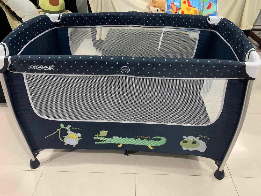 Akeeva Baby Playpen with Changing Station (Category: Cots & Cribs) located in Tanauan. Submitted by rian3721 (Listing ID 1463473894, Image 2). Description: - Dark blue playpen with adorable animal prints - Includes a convenient removable changing station - Features a mobile with hanging toys for entertainment - Mesh sides ensure excellent ventilation - Simple to set up and fold for easy storage - Perfect for keeping your baby safe and engaged.