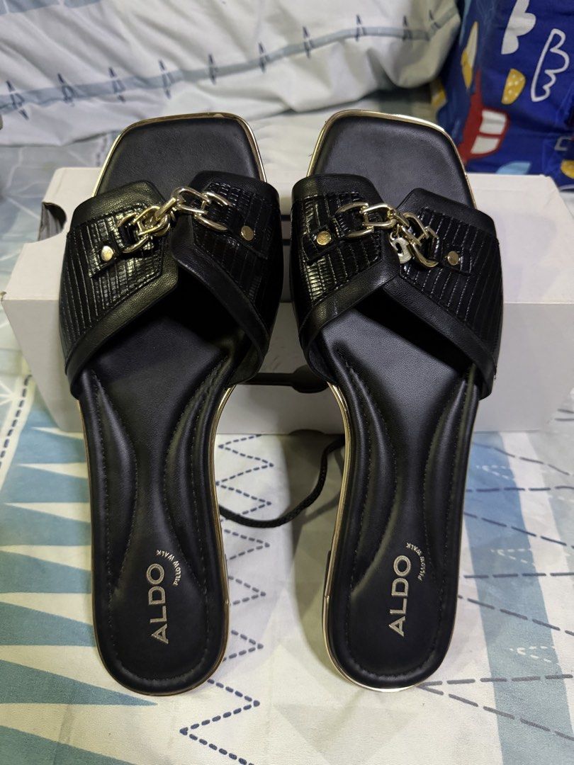 ALDO Alamassi Black Gold Chain Slides Sandals (Category: Flats & Sandals) located in Pasig City. Submitted by aprilluxcloset0812 (Listing ID 1463477029, Image 1). Description: - Brand: ALDO - Color: Black - Style: Slides - Feature: Gold chain detail across the strap - Design: Square toe - Sole: ALDO logo detail - Condition: Comes with original box - Size: 8.5 US / 39 EUR RFS: decluttering EVERYTHING MUST GO‼️Just make a reasonable offer ❤️ All it