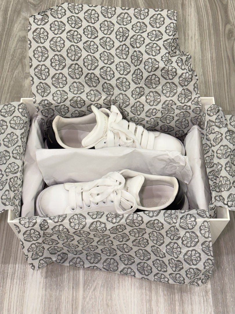 Alexander McQueen Oversized Sneakers White Black (Category: Casual Shoes) located in Manila. Submitted by silent_dosss (Listing ID 1463379053, Image 2). Description: - Authentic Alexander McQueen Oversized Sneakers - Color: White leather with a black heel tab - Iconic chunky sole design - Comes with the original box - Ideal for stylish everyday wear.