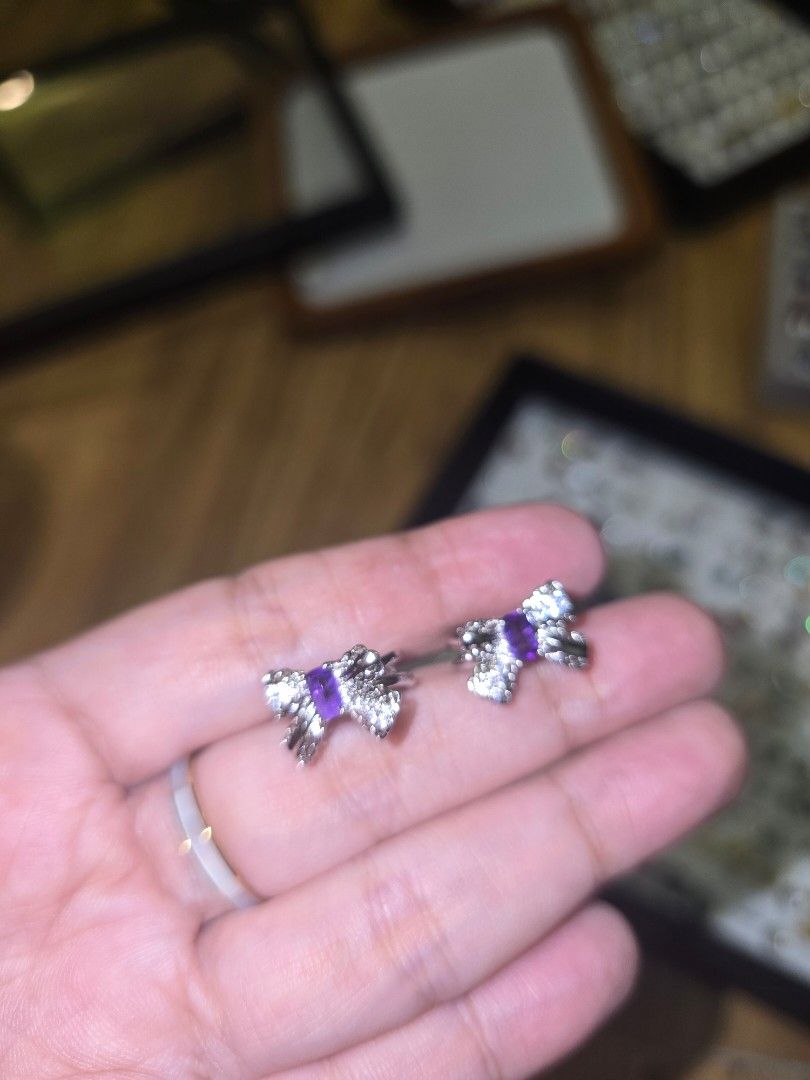 Amehtyst bow ear cuff (Category: Earrings) located in Santa Rosa. Submitted by crystal1.0 (Listing ID 1463385408, Image 3). Description: - Cute silver bow design - Features a purple square stone in the center - Accented with small clear stones for extra sparkle - Clip-on style, perfect for non-pierced ears - Sold as a pair.