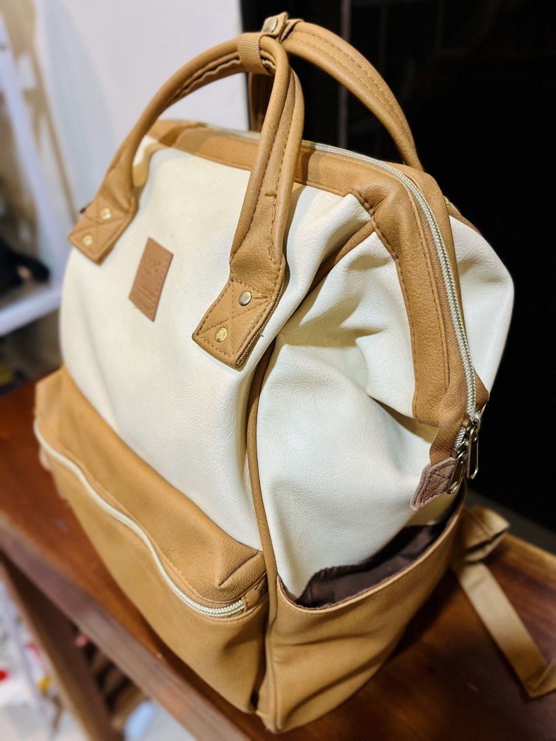 Anello Backpack Cream and Tan (Category: Backpacks) located in Bacolod City. Submitted by vintage_vogue6100 (Listing ID 1463385581, Image 3). Description: Cream and tan Anello backpack. Classic square shape with top handles and adjustable shoulder straps. Front zip pocket and side pockets. Main compartment opens wide. Plenty of space inside for your essentials. Great for daily use or travel..
