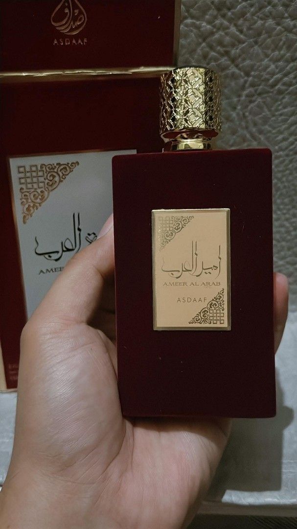 ASDAAF Ameerat Al Arab Eau De Parfum 100ml (Category: Fragrance & Deodorants) located in Quezon City. Submitted by trade_mnl (Listing ID 1463504155, Image 1). Description: From Dubai. Gifted only. My sister prefers the pink one. 90 to 95% full with box. Scannable QR code. - ASDAAF Ameerat Al Arab Eau De Parfum - Natural Spray - 100ml Bottle - Made in UAE - Luxurious maroon velvet-like bottle with gold cap - Maroon box with elegant gold Arabic cal