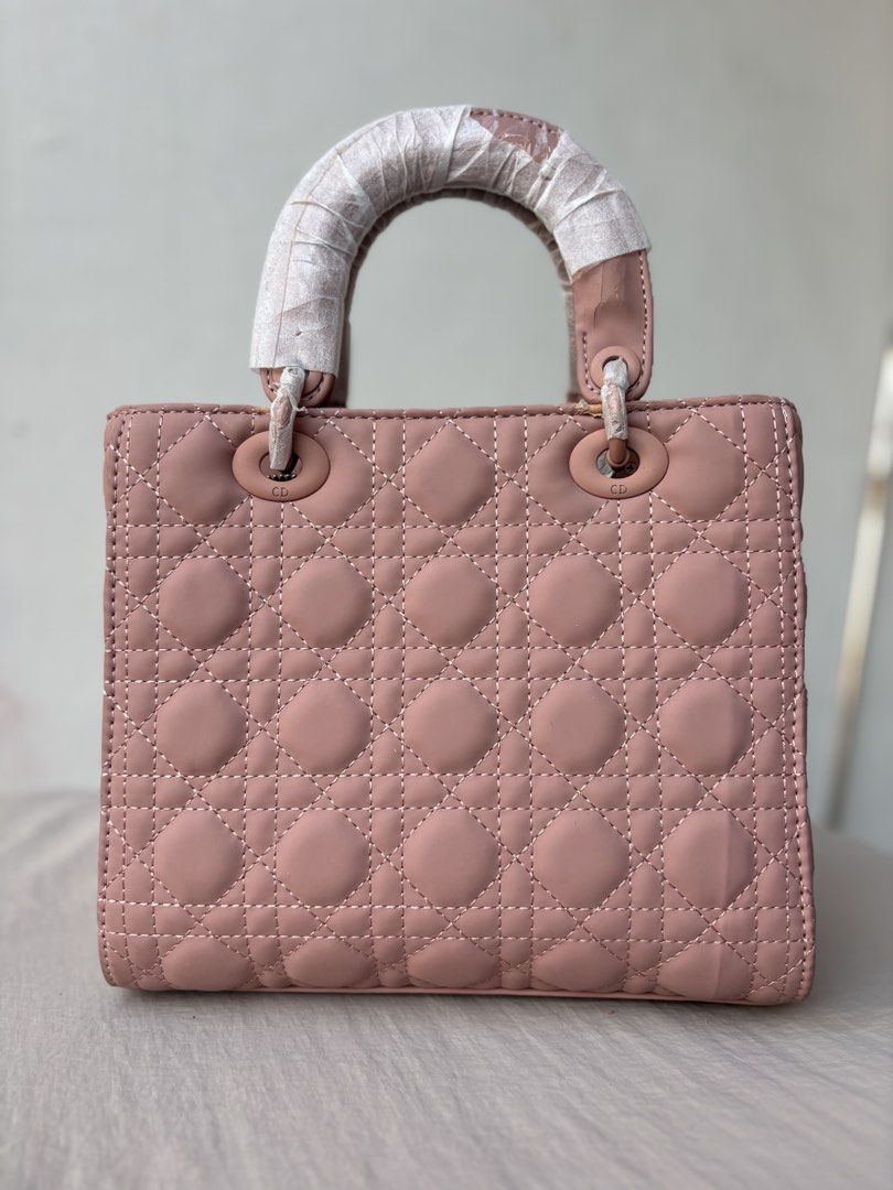 Assorted Bags (Category: Luxury Bags & Wallets) located in Manila. Submitted by dgzmnmariaeunice (Listing ID 1463437954, Image 1). Description: Classic pink Dior Lady Dior bag. Quilted cannage pattern. Top handle with protective wrapping. Iconic CD charms. A timeless piece for any occasion. Very clean inside and out. Comes with dustbag..