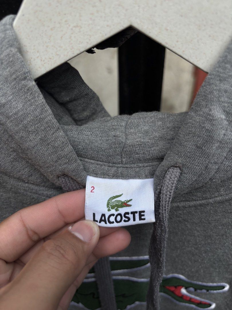 AUTHENTIC LACOSTE BIG LOGO HOODIE🩶 (Category: Coats, Jackets and Outerwear) located in Maasin. Submitted by chevyferna66833 (Listing ID 1463459669, Image 3). Description: L@COSTE BIG LOGO HOODIE🩶 SIZE 2 ON TAG S-M FITTING EXCELLENT CONDITION MINE 1580.