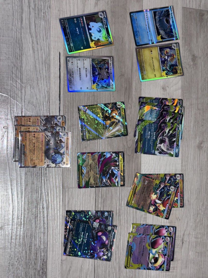 Authentic Pokemon TCG (Trading Cards) Mini Collection *TAKE ALL* (Category: Raw Singles) located in Mandaluyong City. Submitted by Angelo154 (Listing ID 1463457691, Image 3). Description: - Personal Pokemon Card Collection (English and Japanese Cards) - 1UP! Card Binder: Orange Toploader Binder (4-slot) - Sleeves - Additional 100+ Regular Pokemon Cards mostly from (Pitch Black), and a few from (Chaos Rising, Black Bolt, 30th Celebration) *Negotia