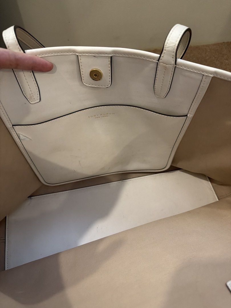 Authentic Tory Burch Tote Bag (Category: Luxury Bags & Wallets) located in Quezon City. Submitted by purpleblush (Listing ID 1463344544, Image 2). Description: - Classic Tory Burch tote bag - Signature logo print in brown, navy, and white - White leather trim and handles - Interior: snap closure pocket and large central compartment - Ideal for everyday use or travel - Spacious interior.
