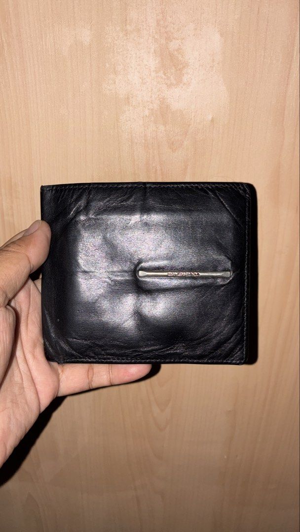 Balenciaga Black Leather Bifold Wallet (Category: Luxury Bags & Wallets) located in Placer. Submitted by talaalond61563 (Listing ID 1463339277, Image 1). Description: - Authentic Balenciaga black leather bifold wallet - Features the iconic Balenciaga Paris logo inside - Ample card slots and compartments for organization - Still has plenty of life and functionality left.