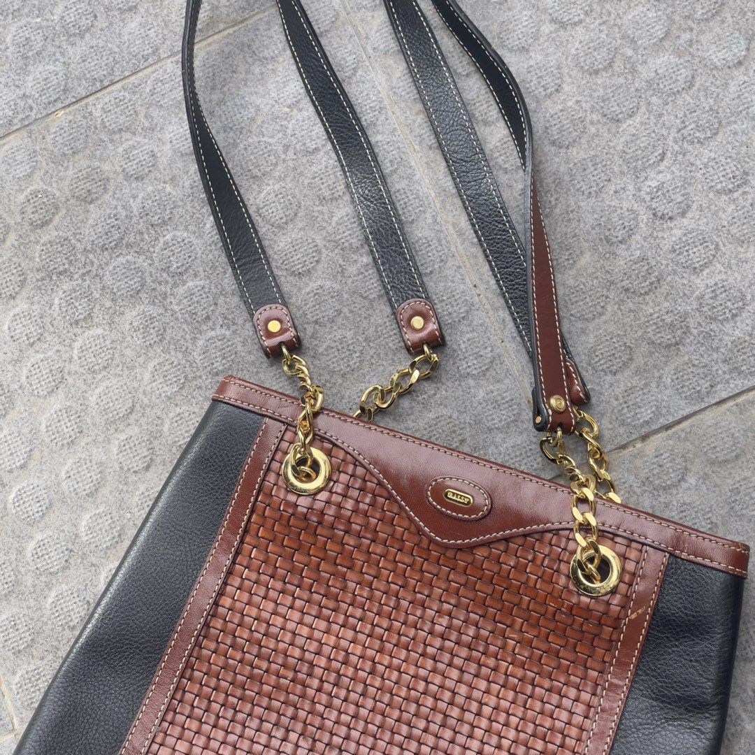 Bally Original Shoulder Bag (Category: Tote Bags) located in Manila. Submitted by xeych (Listing ID 1463399922, Image 1). Description: Vintage Bally Two-Tone Woven Leather Chain Shoulder Bag / Tote ORIGINAL Price: ₱3,700 Color: Two-Tone Black and Rich Brown Condition: Excellent ✅ Material: Gold-tone chain & emblem, Leather Bag Closure: Open top/ Magnetic snap Carry: Comfortable, Dual leather shoulder straps DM / PM for more additional photos and 