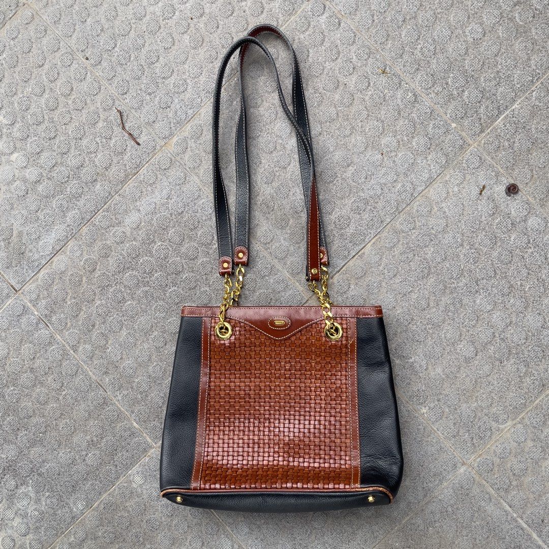 Bally Original Shoulder Bag (Category: Tote Bags) located in Manila. Submitted by xeych (Listing ID 1463399922, Image 2). Description: Vintage Bally Two-Tone Woven Leather Chain Shoulder Bag / Tote ORIGINAL Price: ₱3,700 Color: Two-Tone Black and Rich Brown Condition: Excellent ✅ Material: Gold-tone chain & emblem, Leather Bag Closure: Open top/ Magnetic snap Carry: Comfortable, Dual leather shoulder straps DM / PM for more additional photos and 