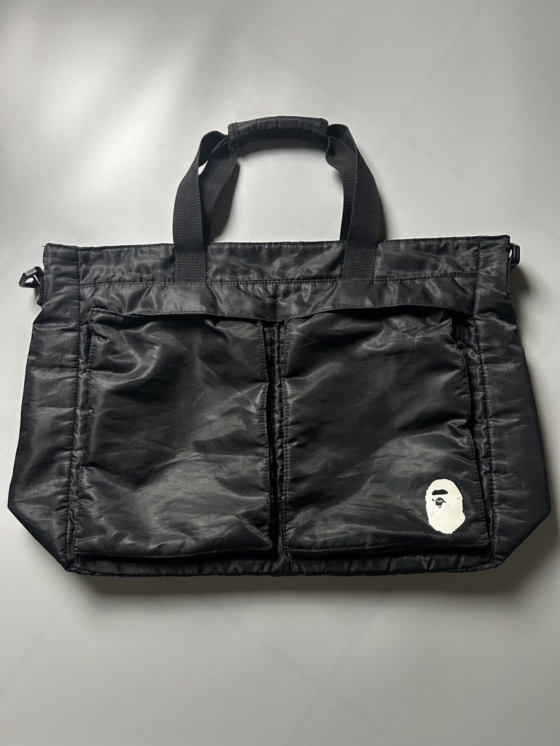 BAPE Black Tote Bag with Ape Head Logo (Category: Tote Bags) located in Tacloban City. Submitted by azthrifting24 (Listing ID 1463393428, Image 1). Description: - Authentic BAPE Black Tote Bag - Features the iconic BAPE Ape Head logo prominently on the front - Two large, convenient front pockets for quick access to essentials - Spacious main compartment offers ample storage for daily necessities or travel items - Equipped with comfortable top han