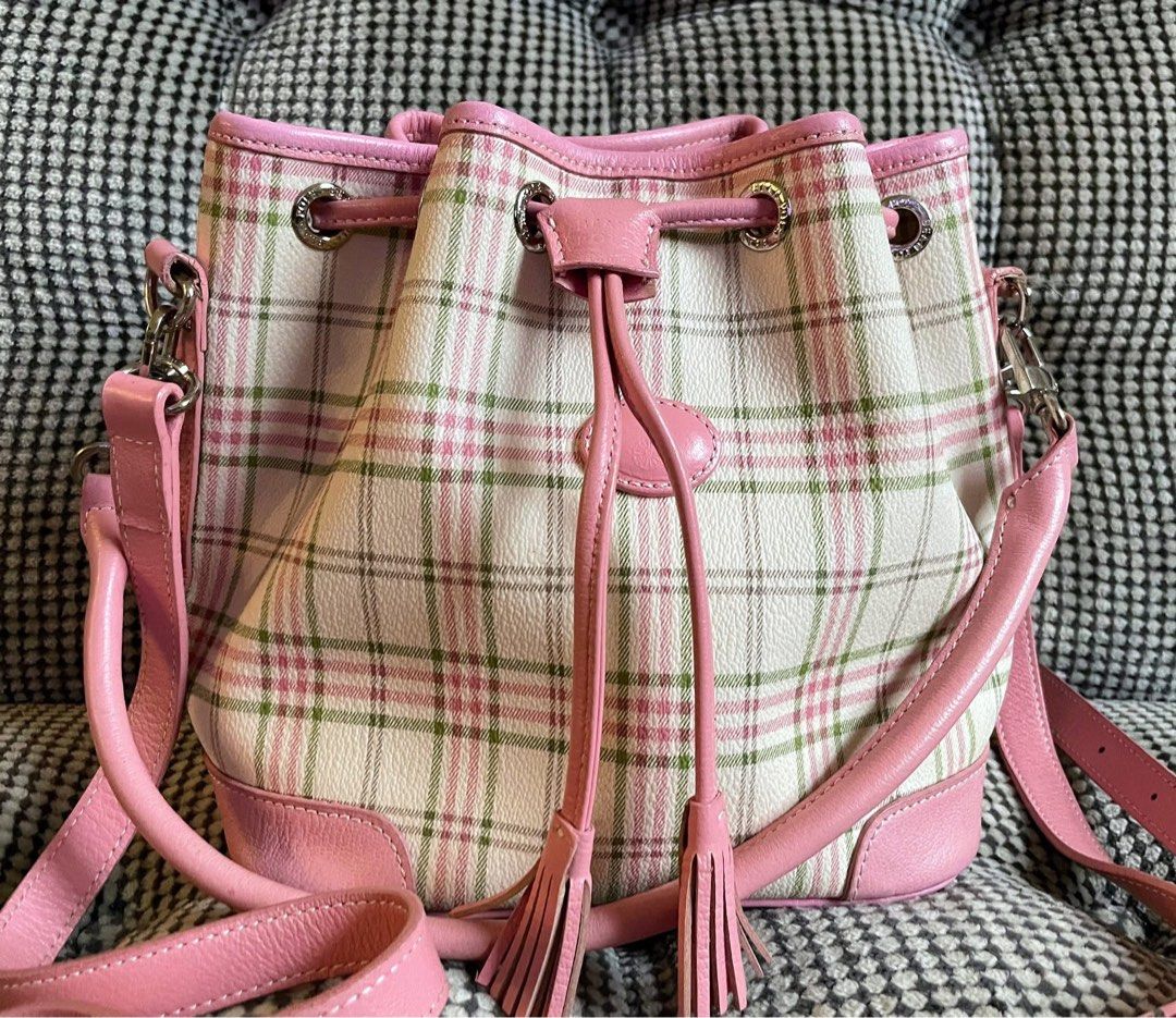 Bean pole plaid bag (Category: Cross-body Bags) located in Bulacan. Submitted by thriftbagcollections (Listing ID 1463439694, Image 2). Description: - Adorable pink plaid bucket bag - White base with a charming pink and green plaid pattern - Stylish pink leather trim and details - Secure drawstring closure with decorative tassels - Includes a convenient top handle - Comes with a long, adjustable strap for versatile carrying - Spacious interior, i