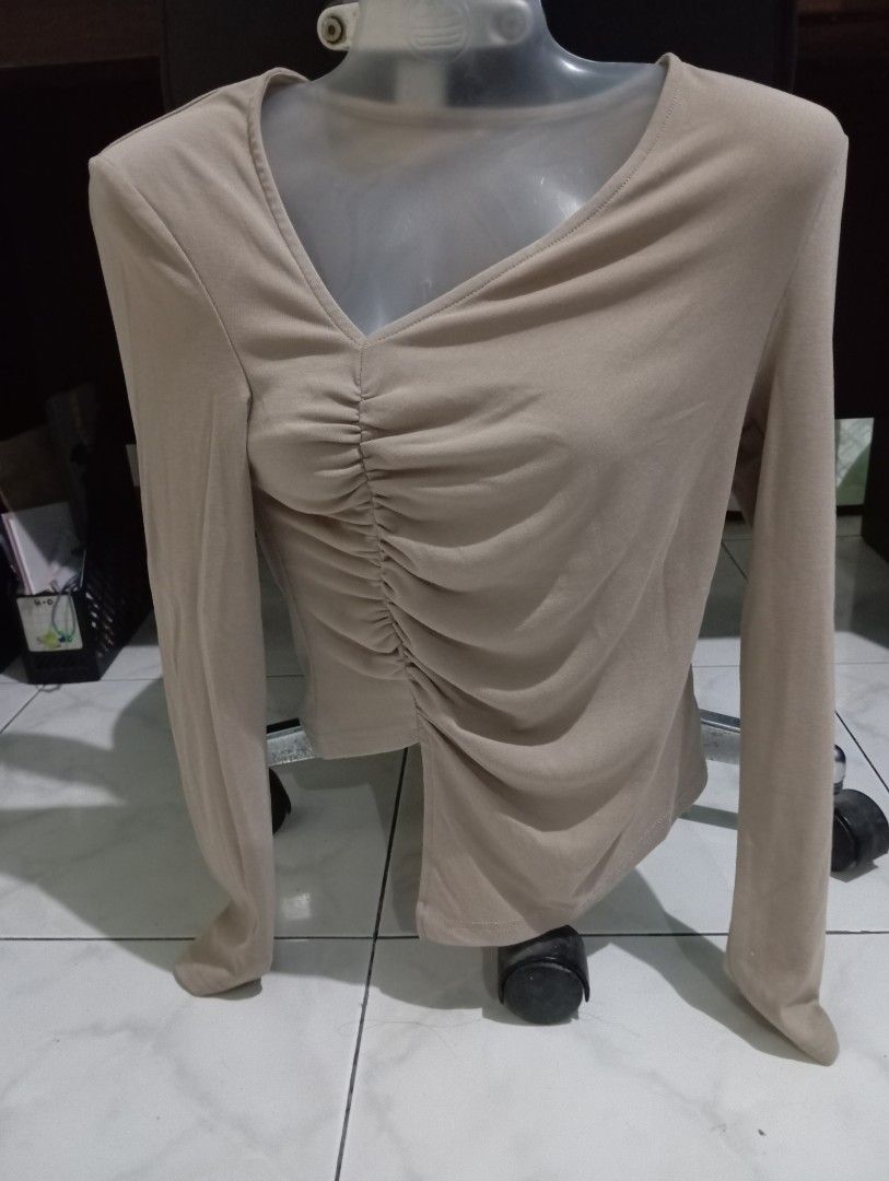 Beige Long Sleeve Ruched V-Neck Top (Category: Longsleeves) located in Dasmarinas. Submitted by kei05 (Listing ID 1463442332, Image 1). Description: - Beige long-sleeved top - Flattering V-neckline - Stylish ruched detail in the front - Comfortable stretchy material - Perfect for pairing with jeans or skirts - Ideal for casual outings or a night out.