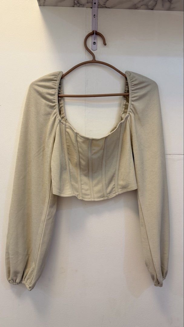 Beige Square Neck Corset Long Sleeve Top (Category: Others Tops) located in Angeles City. Submitted by hooni_park (Listing ID 1463482449, Image 1). Description: - Cute beige top - Square neckline - Long balloon sleeves - Corset-style bodice with vertical seams for a flattering fit - Ribbed texture fabric - Versatile: dress up or down, pairs well with jeans or skirts.