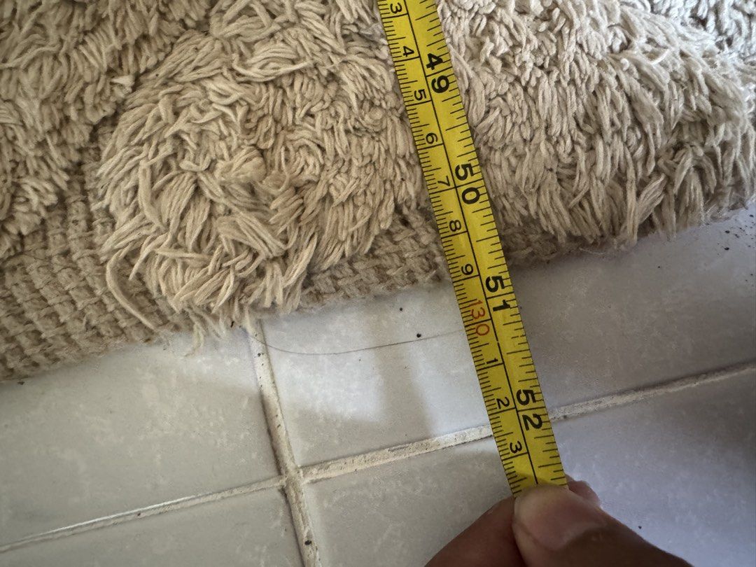 Beige Textured Rug with Tassels (Category: Carpets, Mats & Flooring) located in Mabalacat. Submitted by joktrinidad (Listing ID 1463545033, Image 3). Description: - Beige textured rug with a stylish geometric pattern. - Features charming tassels on both ends. - Approximate dimensions: 80cm x 50cm. - Adds a warm and cozy ambiance to any room. - Ideal for enhancing your living room or bedroom decor. - Simple to maintain and clean..