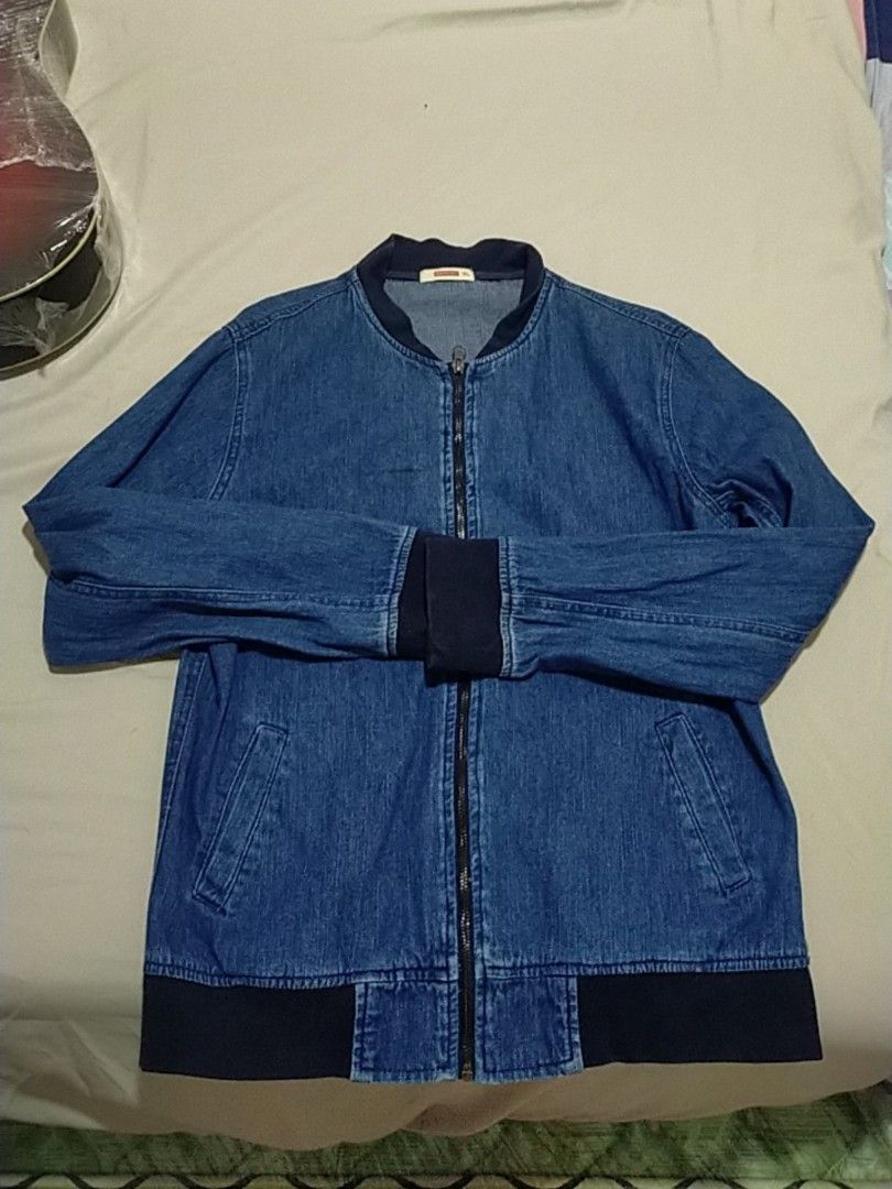 BENCH Denim Bomber Jacket XL (Category: Coats, Jackets and Outerwear) located in Paranaque City. Submitted by gentle.declutter (Listing ID 1463398162, Image 2). Description: ✅ Brand: BENCH — trusted local brand ✅ Style: Denim bomber jacket — classic zip-up design ✅ Color: Medium blue denim with dark navy ribbed collar, cuffs & hem ✅ Features: Full metal zipper • 2 side slip pockets • lightweight soft denim ✅ Size: XL — relaxed comfortable fit ✅ C