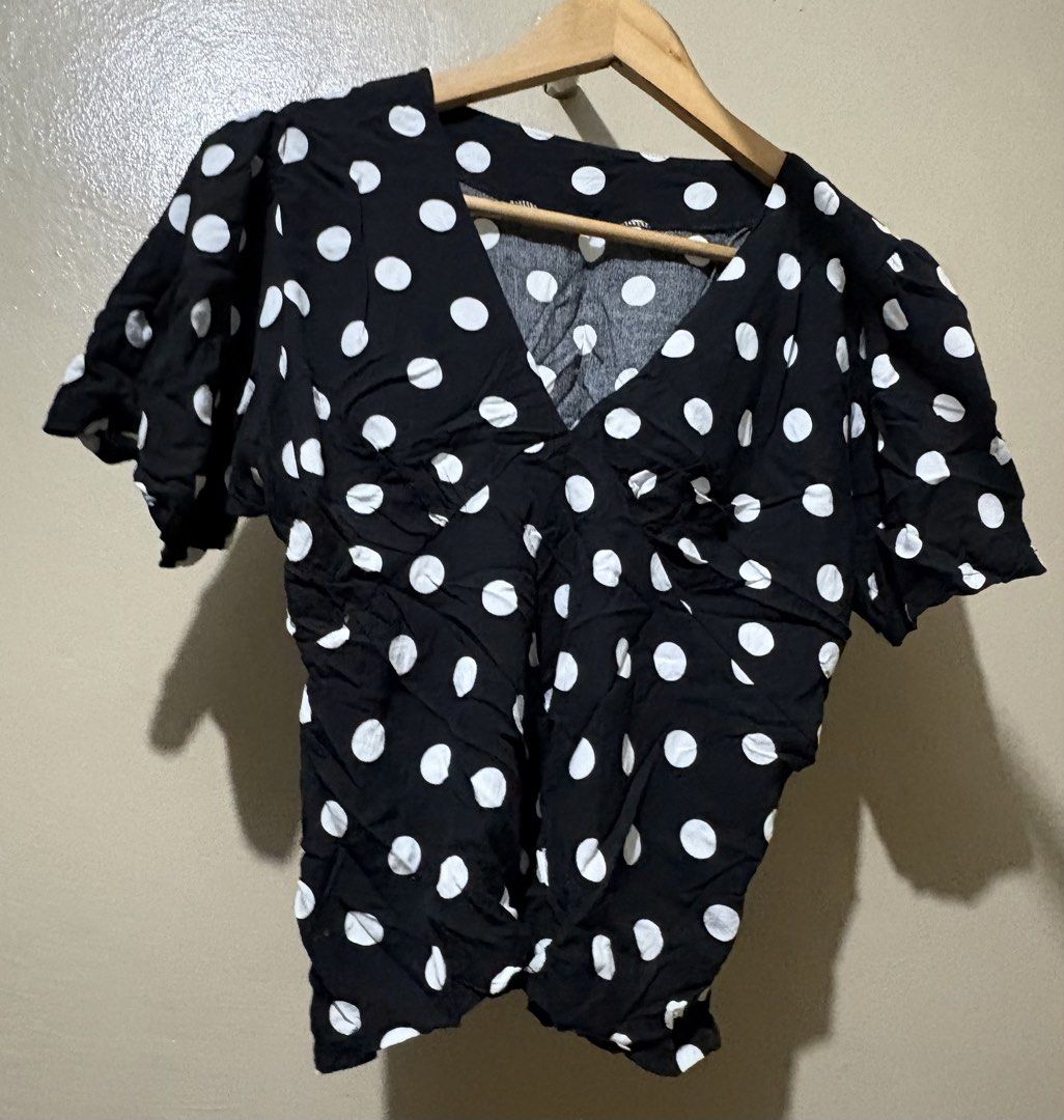 Black and White Polka Dot V-Neck Top (Category: Blouses) located in Manila. Submitted by stella_mari27 (Listing ID 1463460069, Image 1). Description: - Adorable black top with classic white polka dots. - Flattering V-neckline. - Chic short puff sleeves. - Unique crinkled fabric texture. - Versatile for casual outings or dressing up. - Effortlessly pairs with jeans or skirts..