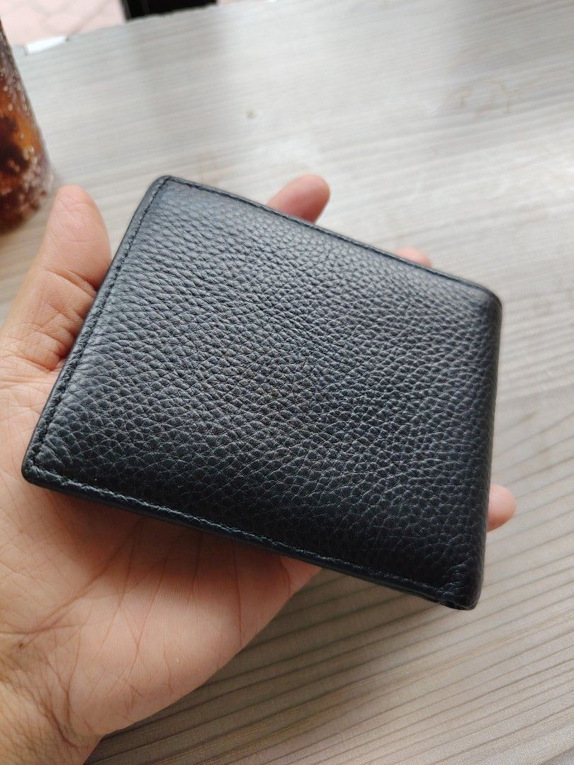 Black Genuine Cowhide Leather Bifold Wallet (Category: Wallets & Card holders) located in Manila. Submitted by purediamond888 (Listing ID 1463379308, Image 2). Description: - Classic black bifold wallet - Genuine cowhide leather with textured finish - Multiple card slots for ample storage - Clear ID window for easy access - Simple, functional, and stylish design - Perfect for everyday use.