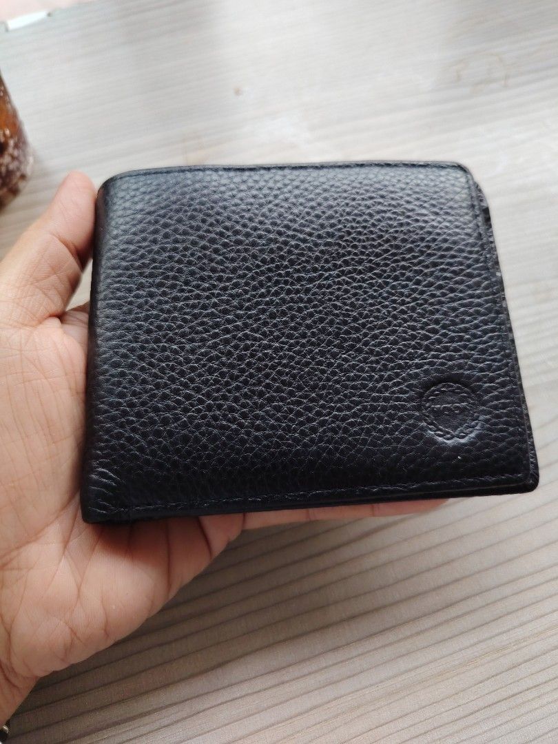 Black Genuine Cowhide Leather Bifold Wallet (Category: Wallets & Card holders) located in Manila. Submitted by purediamond888 (Listing ID 1463379308, Image 1). Description: - Classic black bifold wallet - Genuine cowhide leather with textured finish - Multiple card slots for ample storage - Clear ID window for easy access - Simple, functional, and stylish design - Perfect for everyday use.