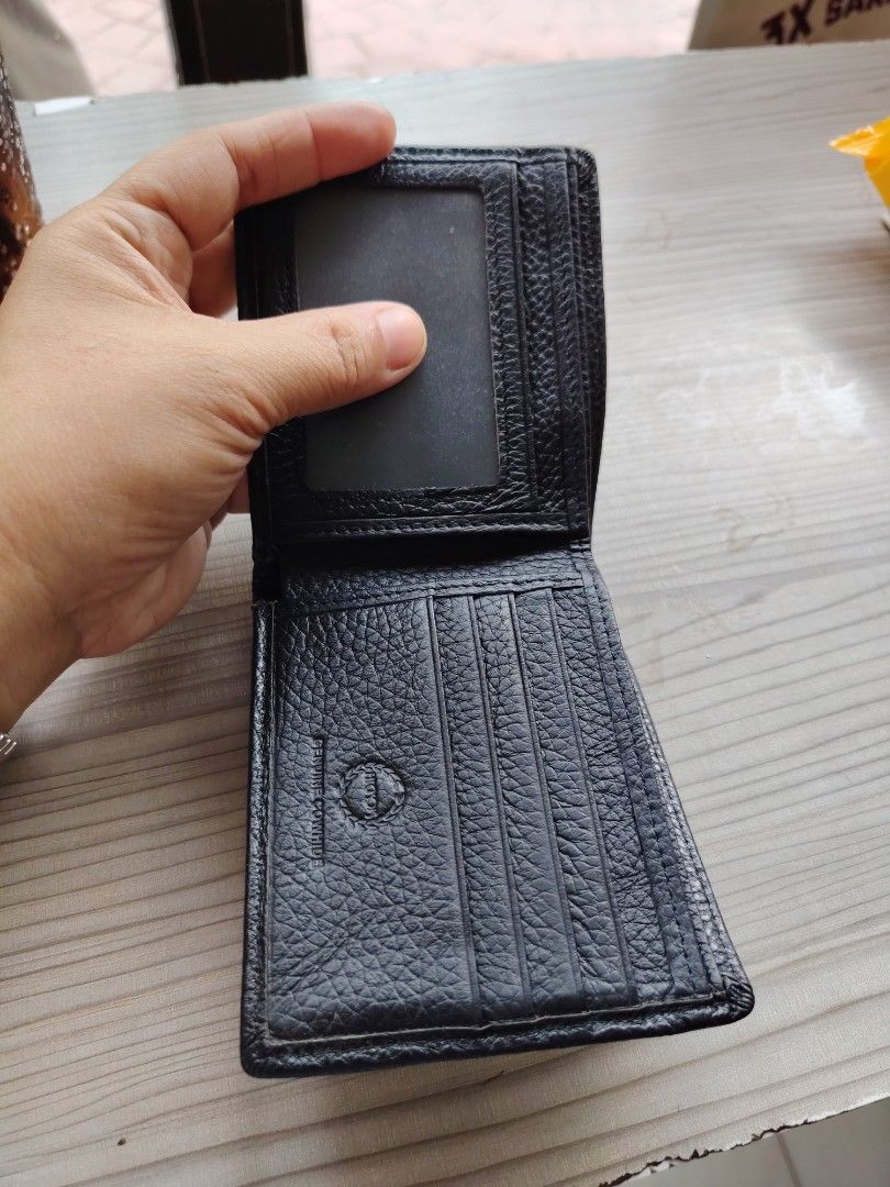 Black Genuine Cowhide Leather Bifold Wallet (Category: Wallets & Card holders) located in Manila. Submitted by purediamond888 (Listing ID 1463379308, Image 3). Description: - Classic black bifold wallet - Genuine cowhide leather with textured finish - Multiple card slots for ample storage - Clear ID window for easy access - Simple, functional, and stylish design - Perfect for everyday use.
