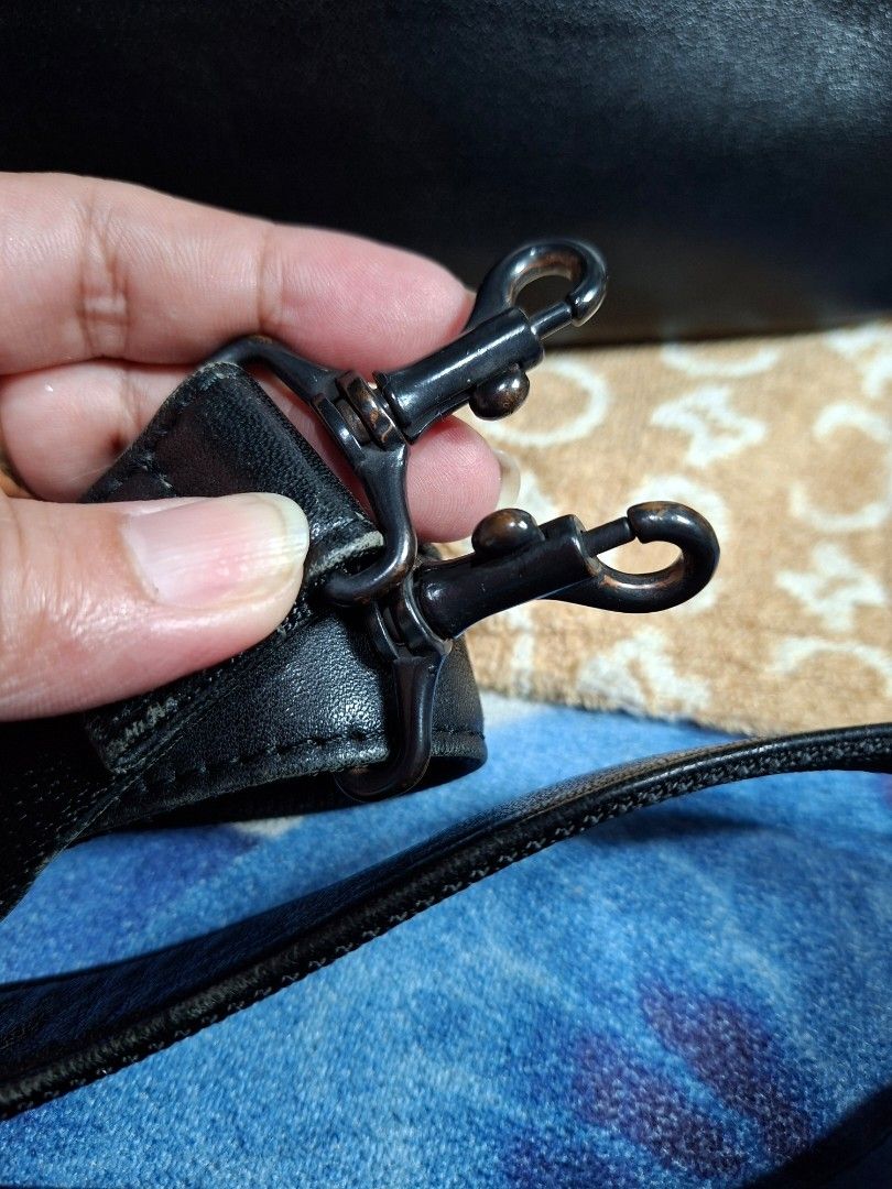 Black Leather Bag with Strap (Category: Luxury Bags & Wallets) located in Lucena. Submitted by dai_suki (Listing ID 1463475995, Image 2). Description: - Genuine black leather bag - Detachable shoulder strap with metal clasps - 'IM' logo on zippers - Ideal size for everyday essentials - Interior is clean and well-maintained - Shows minor signs of wear on the strap and hardware.