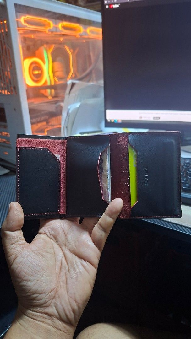 Black Leather Card Holder Wallet with Red Stitching (Category: Wallets & Card holders) located in Caloocan City. Submitted by mackulitzz36892 (Listing ID 1463397540, Image 3). Description: - Slim black leather card holder - Textured hexagon pattern on front - Red stitching detail - Interior card slots - Built-in metal card dispenser - Includes original box - Compact and stylish for daily use.