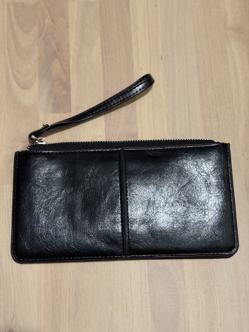 Black Leather Wristlet Wallet with Zipper (Category: Wallets & Card holders) located in Manila. Submitted by emchi19 (Listing ID 1463537219, Image 2). Description: - Classic black leather wristlet - Secure zipper closure - Detachable wrist strap for versatility - Ample space for cards and cash - Ideal for quick errands or nights out - Simple and timeless design.