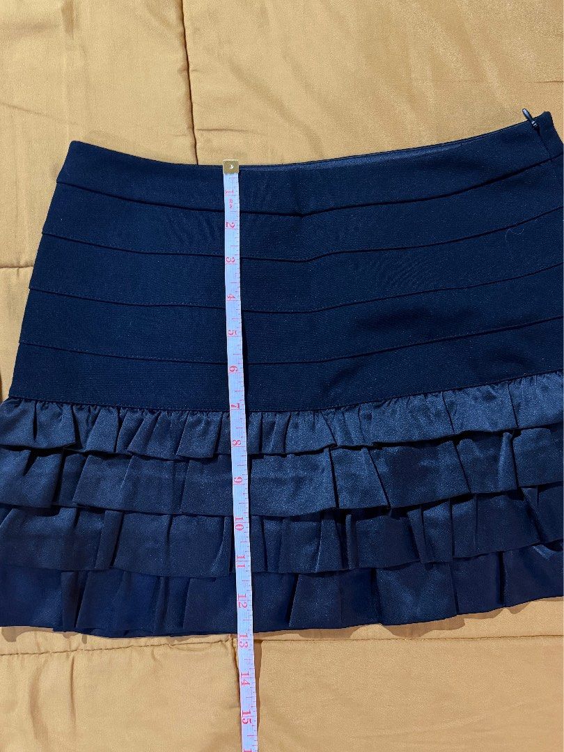 Black Ruffled Mini Skirt (Category: Skirts) located in Mandaluyong City. Submitted by xela.tings (Listing ID 1463453608, Image 3). Description: Horizontal pleating detail on the front Ruffled satin trim along the hem Side zipper closure .