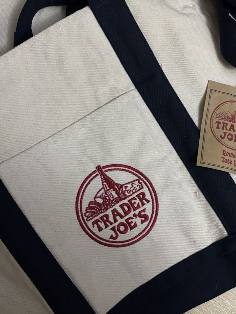 [BNWT] Trader Joe’s Navy Tote Bag (Category: Tote Bags) located in Paranaque City. Submitted by margauxm (Listing ID 1463475636, Image 2). Description: [TRADER JOE’S — Navy Tote Bag] — Brand new!! Straps are in Navy — Bought in Trader Joe’s Houston, Texas — Material is thick and durable — Perfect for everyday use, for errand days, or anywhere! AVAILABLE QUANITITY: 2 .