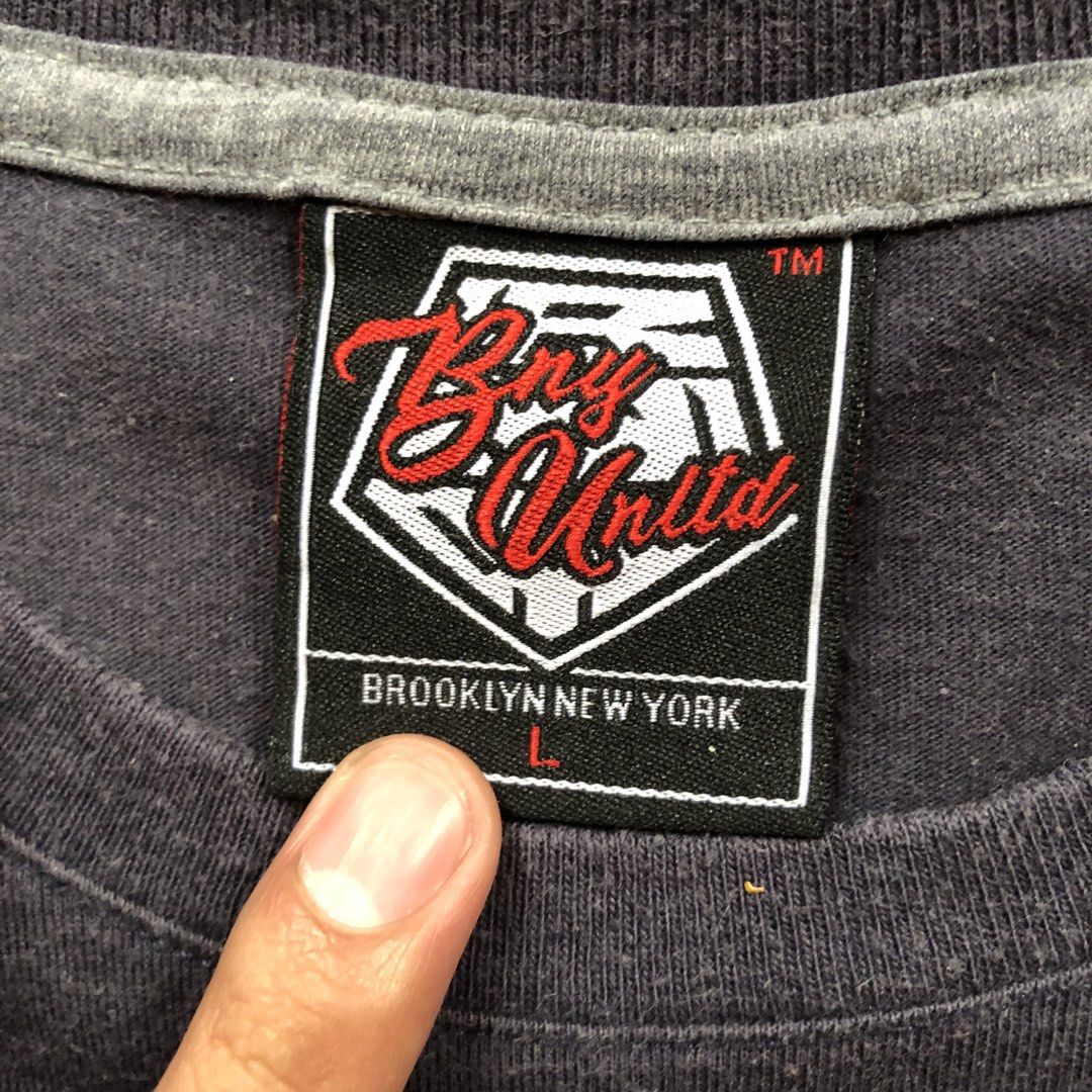 Bny Utd Tee (Category: Tshirts & Polo Shirts ) located in Manila. Submitted by dopethrift.cat (Listing ID 1463396490, Image 2). Description: Dimension: Inches Width: 19" Length: 25" Sleeve: 8" mop: gcash ship: lalamove or jnt - Grey Bny Utd T-shirt - Size: Large (L) - Unique checkered pattern across the chest - Chest pocket detail - Proudly made in Brooklyn, New York - Care: Machine wash cold with similar colors, do not bleach, tumble dry low, wa