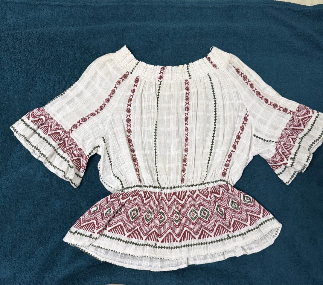 bohemian off-shoulder (Category: Blouses) located in Quezon City. Submitted by baguetteparangkasalananko (Listing ID 1463451885, Image 1). Description: Chic white off-shoulder top with beautiful ethnic embroidery. Features elastic neckline and waist, peplum hem, and flared sleeves. issues: yellow stains .