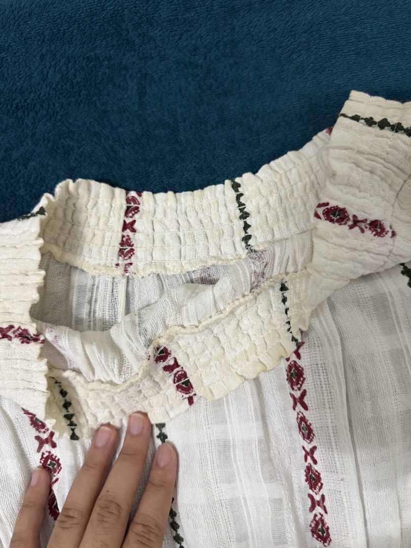 bohemian off-shoulder (Category: Blouses) located in Quezon City. Submitted by baguetteparangkasalananko (Listing ID 1463451885, Image 2). Description: Chic white off-shoulder top with beautiful ethnic embroidery. Features elastic neckline and waist, peplum hem, and flared sleeves. issues: yellow stains .