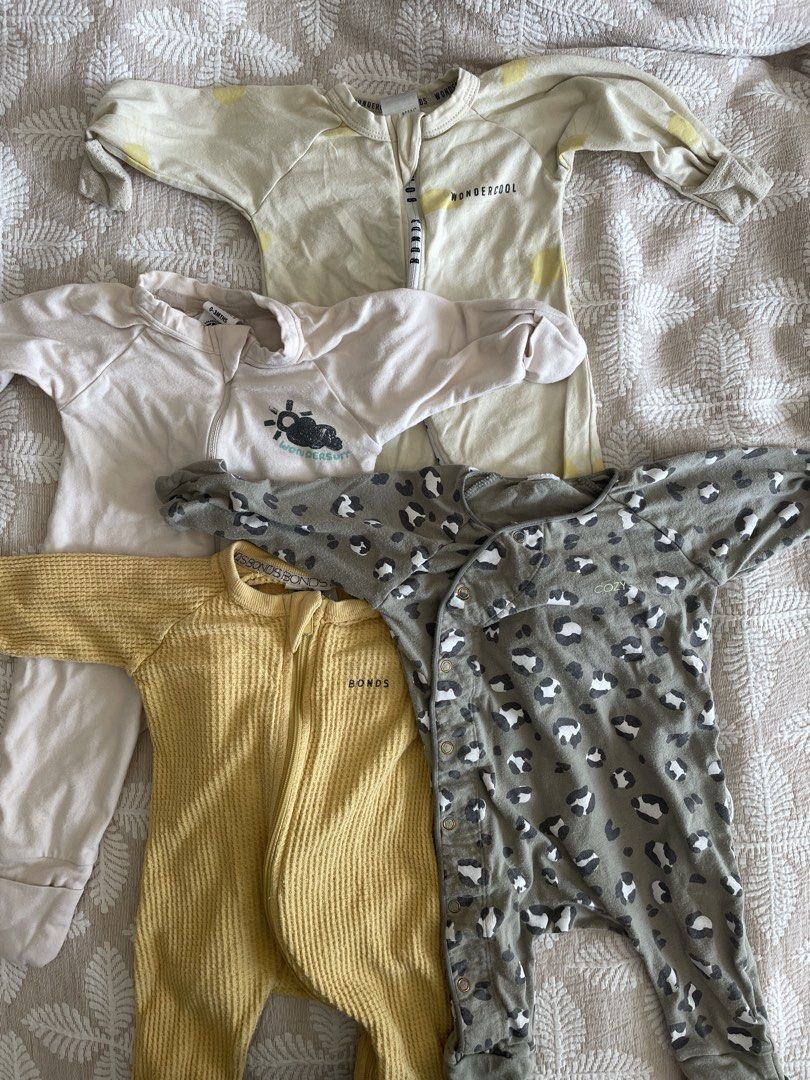 Bonds, Wondercool, Bonds Baby Onesies Bundle (Category: Babies & Kids Fashion) located in Pasig City. Submitted by ourpreloved.shop (Listing ID 1463374361, Image 1). Description: - Bundle of 4 long-sleeved baby onesies with feet. - Includes: Bonds waffle knit (yellow), Wondercool (cream with yellow accents), cream with graphic print, and grey leopard print..