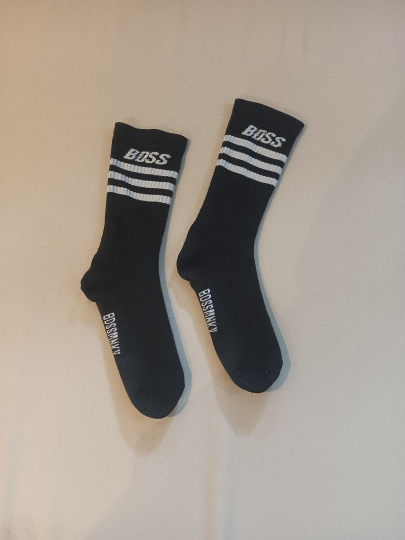 Boss Long Socks (Category: Socks) located in Muntinlupa City. Submitted by irene.aragon.navarro (Listing ID 1463347592, Image 1). Description: - Brand: BOSS - Color: Black with white stripes - Style: Crew length socks - Features: BOSS logo on top, 'BOSSMAN' text near ankle - Ideal for: Casual wear, sports activities.