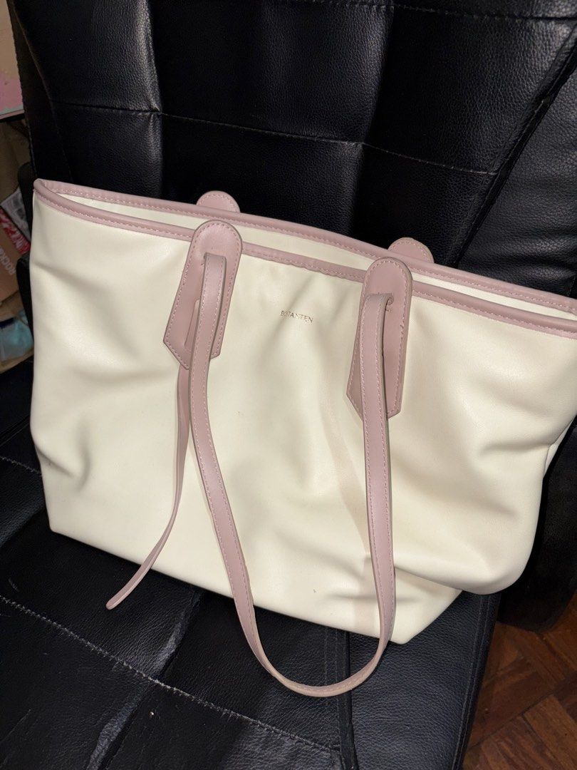 Bostanten Tote Bag (Category: Tote Bags) located in Manila. Submitted by rare_pretty_finds (Listing ID 1463440648, Image 1). Description: - Stylish cream tote bag with elegant pink trim and handles. - Spacious interior, ideal for everyday essentials. - Comfortable handles for easy carrying. - Versatile design suitable for school, work, or casual outings. 📍Quezon City.