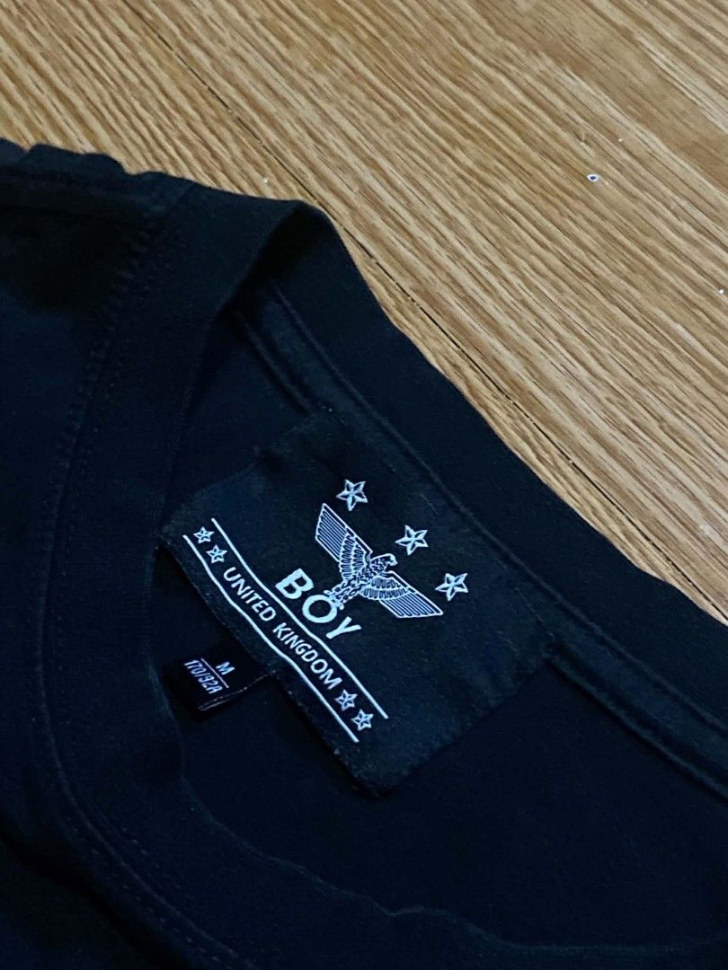 BOY London Eagle T-Shirt Black Size M (Category: Tshirts & Polo Shirts ) located in Manila. Submitted by re1n.findz (Listing ID 1463453708, Image 2). Description: - Authentic Black BOY London T-shirt - Features iconic eagle graphic and BOY logo - Size: Medium (M) - Made in the United Kingdom - Includes a small metal tag with 'HERITAGE SINCE 1976' - Perfect staple piece for any wardrobe.