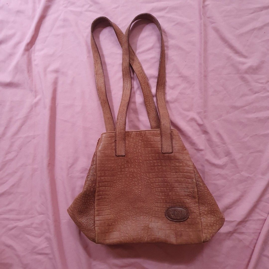 Brown Crocodile Embossed Leather Tote Bag (Category: Tote Bags) located in Paranaque City. Submitted by cobien (Listing ID 1463459971, Image 2). Description: - Stylish brown leather tote bag - Luxurious crocodile embossed texture - Generous size: 17 x 10.5 inches - Comfortable 13-inch handle drop - Secure zip closure for the main compartment - Note: Minor scuff marks on the bottom - flaw: 1 missing foot, signs of use, 1 strap needs re-sew - Ideal