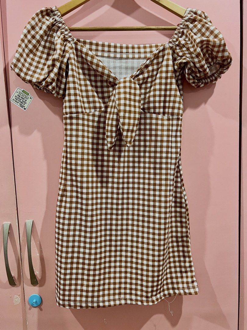 Brown Gingham Puff Sleeve Tie Front Mini Dress (Category: Dresses) located in Manila. Submitted by purgeout (Listing ID 1463553039, Image 1). Description: - Cute brown gingham mini dress - Features puff sleeves - Tie front detail - Square neckline - Ideal for picnics or casual outings - Versatile styling with sandals or sneakers.