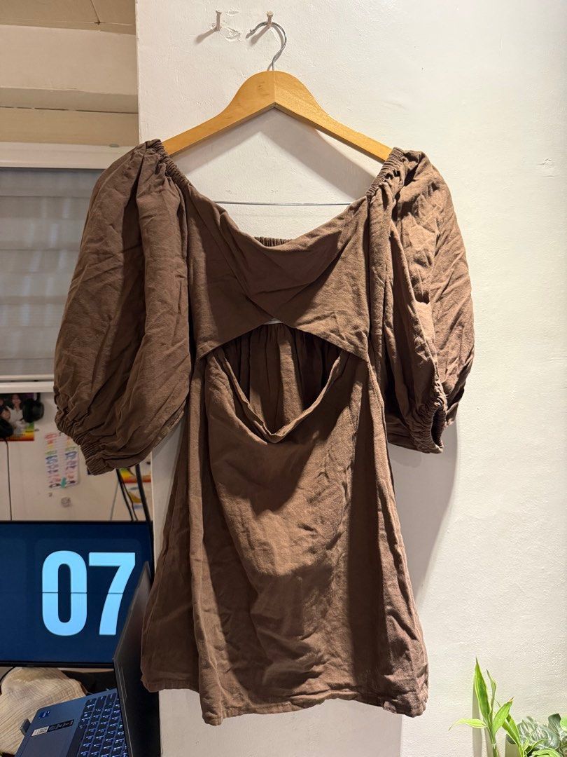 Brown Puff Sleeve Cutout Mini Dress (Category: Dresses) located in Manila. Submitted by jicka (Listing ID 1463329947, Image 2). Description: - Cute brown mini dress - Features puff sleeves - Front cutout detail - Back cutout detail - Versatile for casual or night out - Pairs well with sneakers or heels - Comfortable fabric - Great fit - Bought for ₱450. Selling for ₱139.