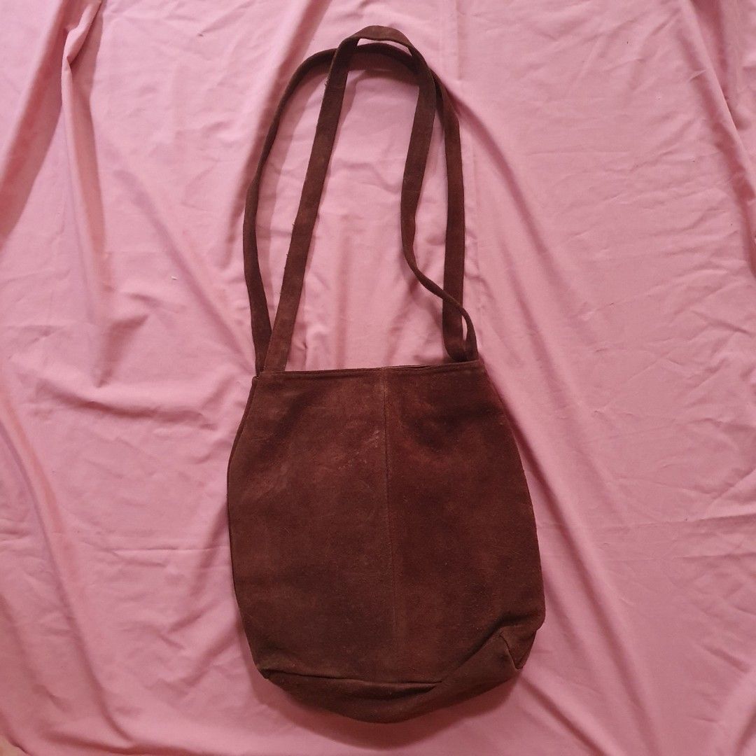 Brown Suede Shoulder Bag (Category: Shoulder Bags) located in Paranaque City. Submitted by cobien (Listing ID 1463461214, Image 2). Description: - Soft brown suede material - Simple design with two comfortable straps - Interior features a stylish patterned lining - Secure magnetic snap closure - Ample space for all your essentials - has signs of use on the - Ideal for everyday use leather.